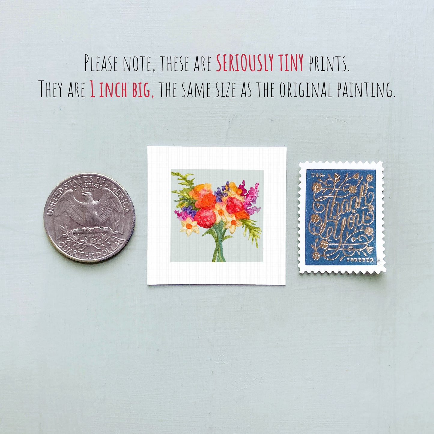 three small prints: a silver coin, a framed print of a colorful floral arrangement, and a blue postage stamp with gold lettering.