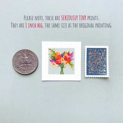 three small prints: a silver coin, a framed print of a colorful floral arrangement, and a blue postage stamp with gold lettering.