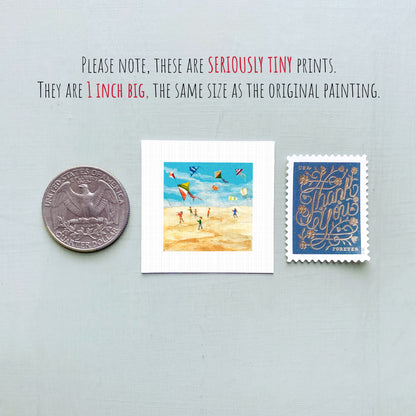 three small prints: a quarter, a postage stamp, and a painting of kites.