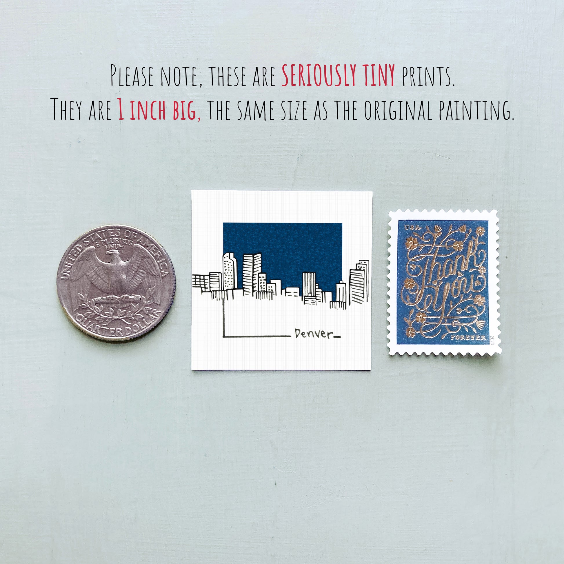 a collection of three items: a quarter, a small square print of a city skyline, and a postage stamp.