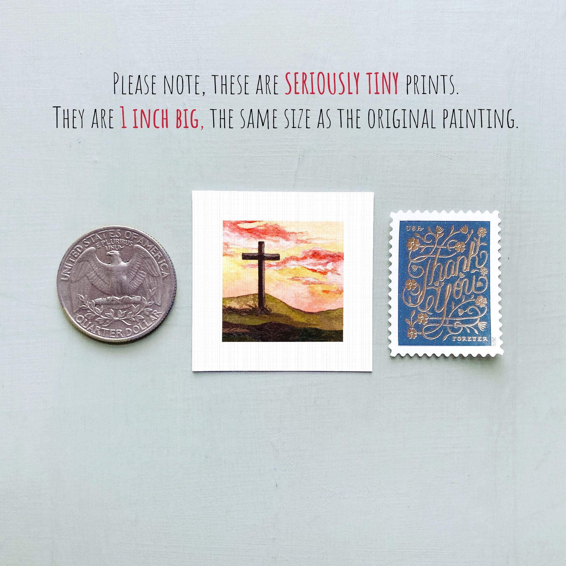 a collection of three small items: a quarter, a painting of a cross on a hill, and a postage stamp.