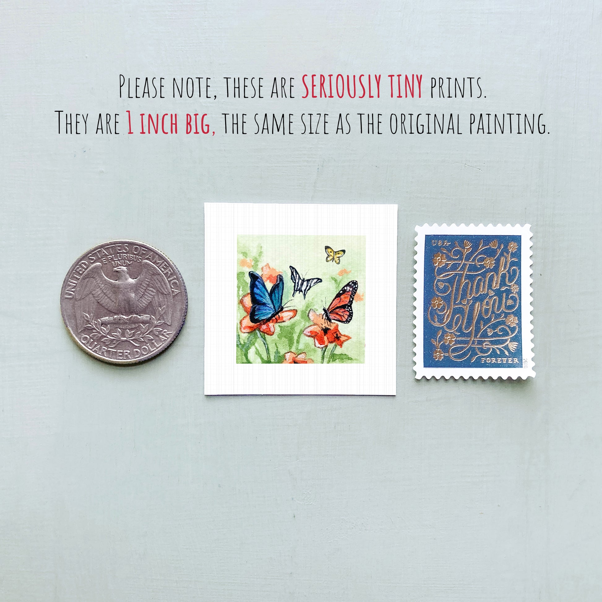 three small prints: a silver coin, a square print of butterflies on flowers, and a blue postage stamp with gold lettering.