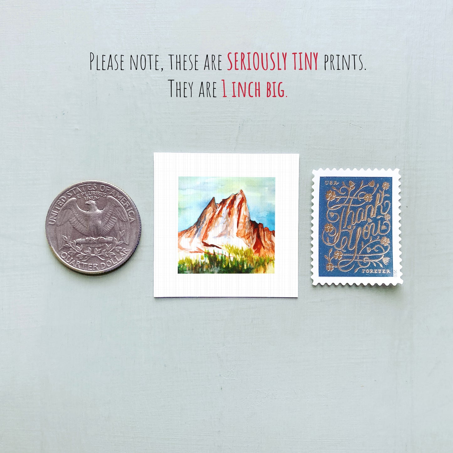 a collection of three small items: a quarter, a postcard with a mountain landscape, and a postage stamp.