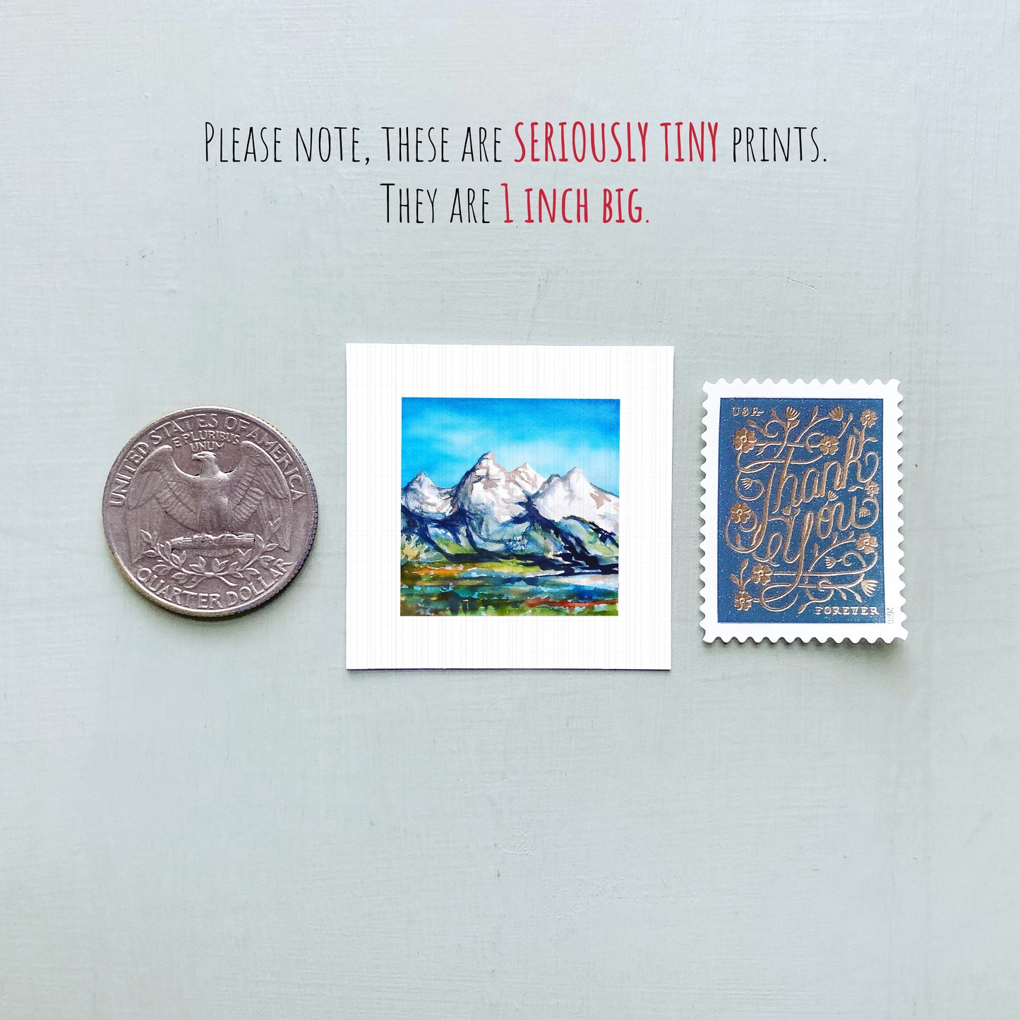 a collection of three small prints, including a coin, a postcard, and a stamp, all of which are described as "seriously tiny prints" and "1 inch big".