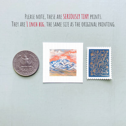 three small artworks or prints, including a coin, a postcard, and a painting, all of which are described as "seriously tiny prints" and "1 inch big" in the provided text.