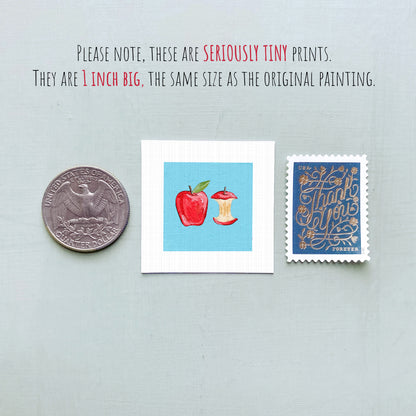 three small prints: a United States quarter, a small square print with an apple and an apple core, and a blue postage stamp with gold lettering.