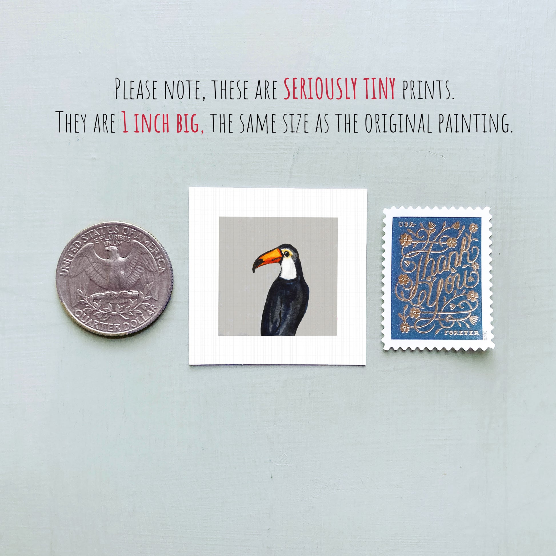 a small, 1-inch-big print of a toucan, a 1-inch-big coin, and a 1-inch-big postage stamp.