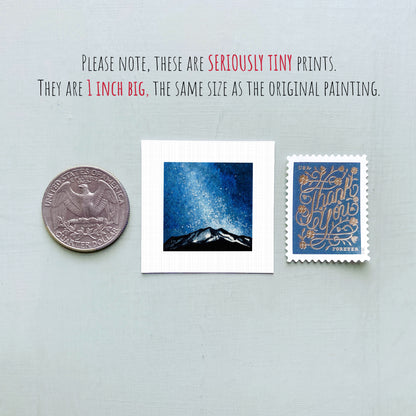 three small prints: a quarter, a square print of a night sky, and a postage stamp.