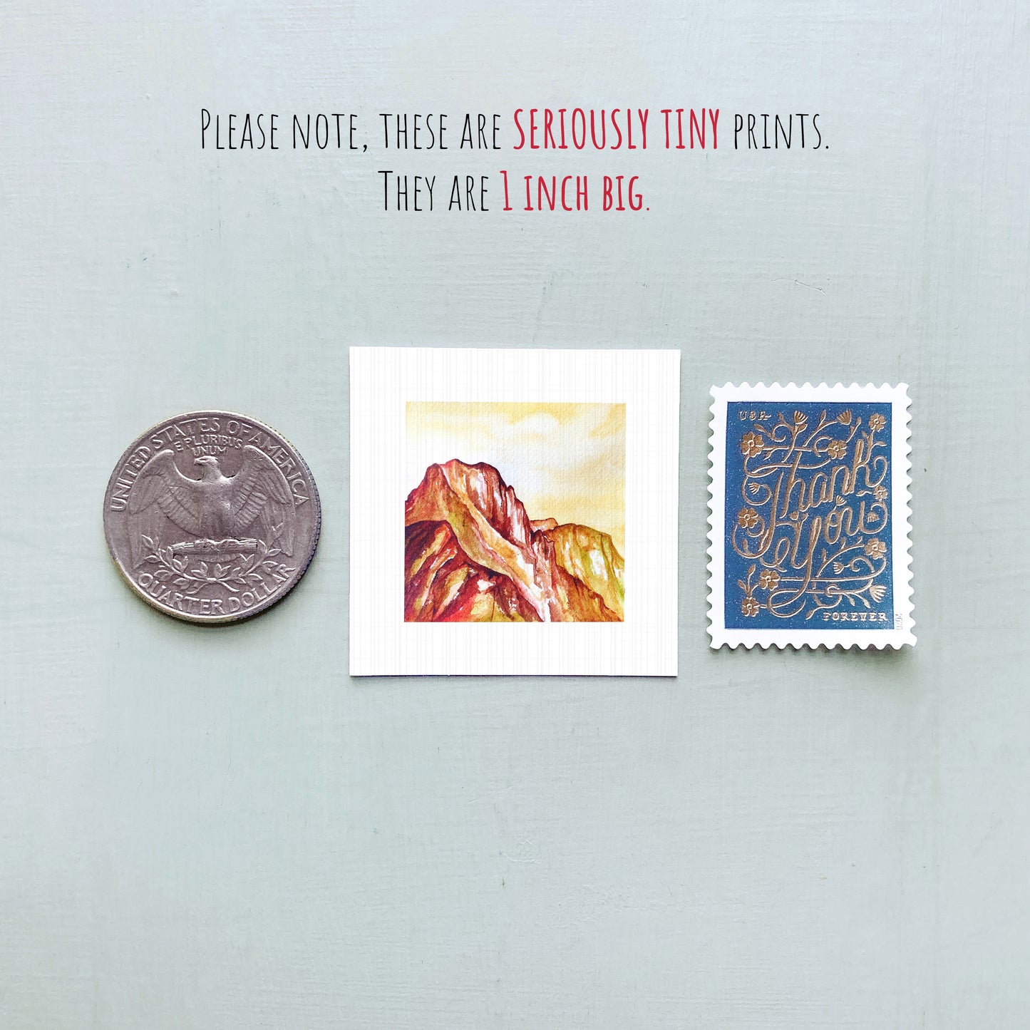 a collection of three small items: a United States quarter, a postcard with a mountain landscape, and a postage stamp.