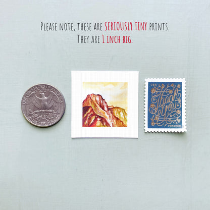 a collection of three small items: a United States quarter, a postcard with a mountain landscape, and a postage stamp.