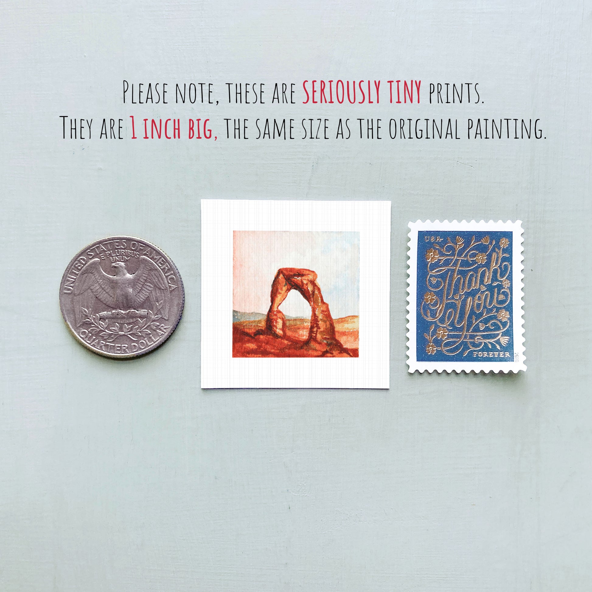 three small prints: a quarter, a postage stamp, and a painting of a rock formation.