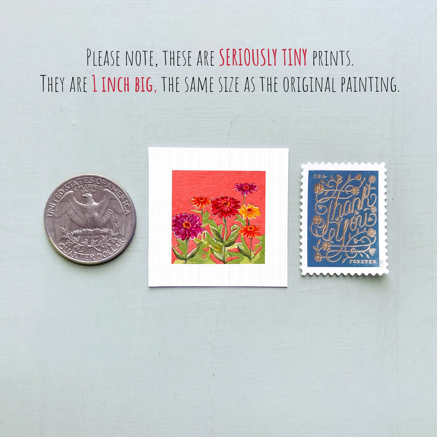 three small prints: a silver coin, a white square print with a red background featuring flowers, and a blue postage stamp with gold lettering.