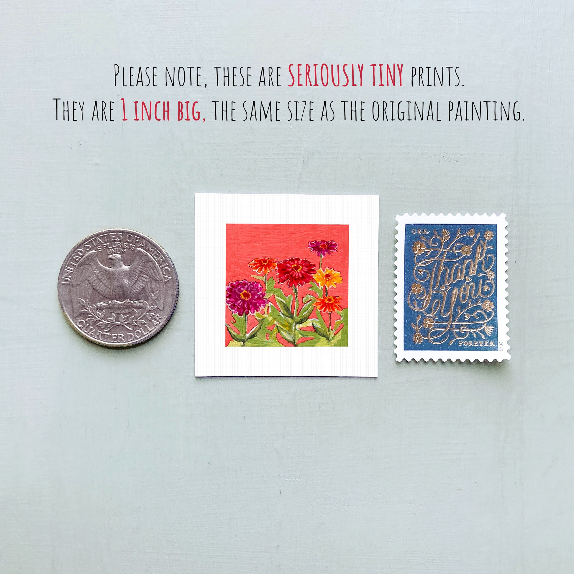 three small prints: a silver coin, a white square print with a red background featuring flowers, and a blue postage stamp with gold lettering.