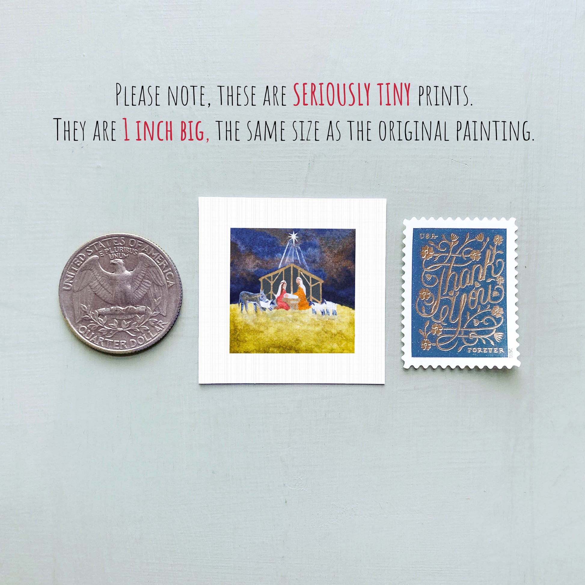 three small prints: a silver coin, a square print of a nativity scene, and a blue postage stamp.