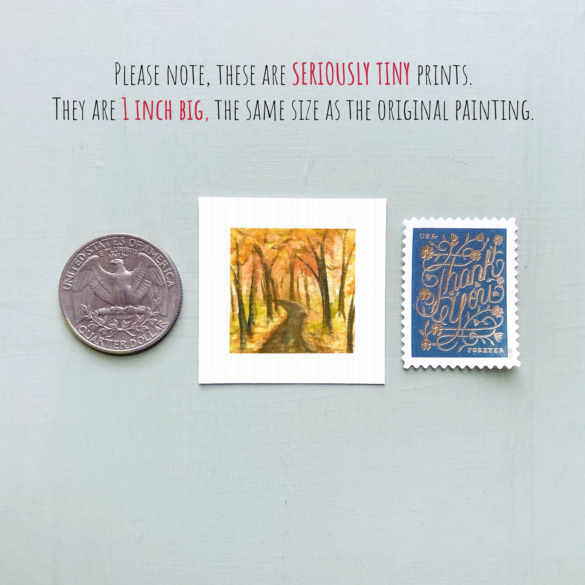 three small artworks or prints, including a coin, a painting of a forest path, and a postage stamp, all placed on a light blue background.