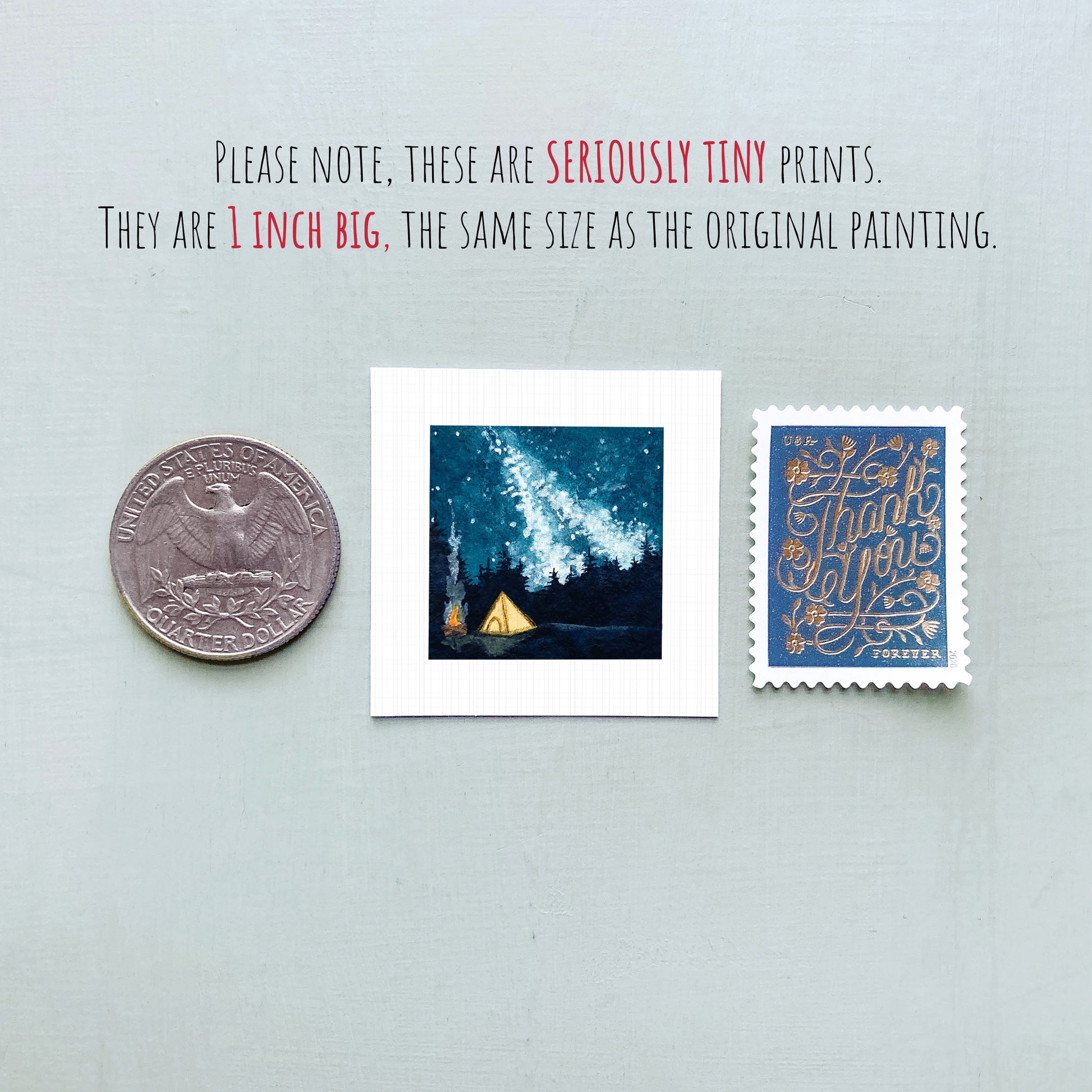three small prints: a United States quarter, a square print of a night sky with a tent, and a blue postage stamp with gold lettering.