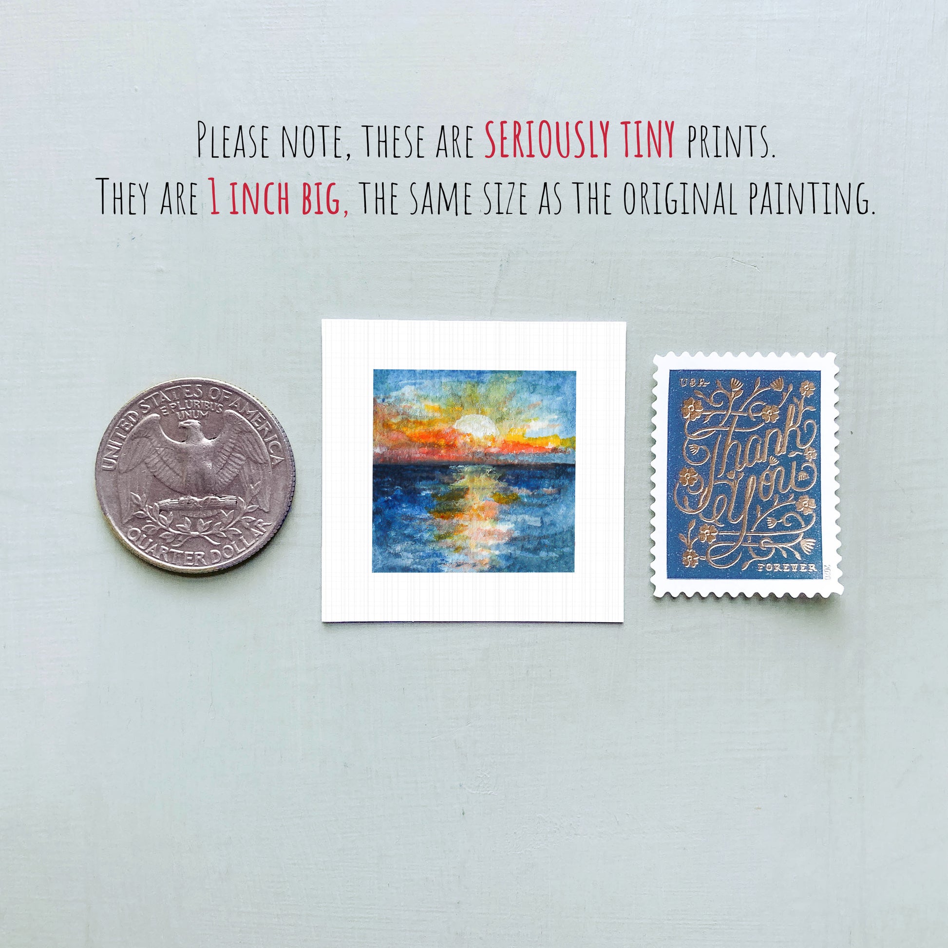 three small artworks: a quarter, a square print of a sunset, and a postage stamp.