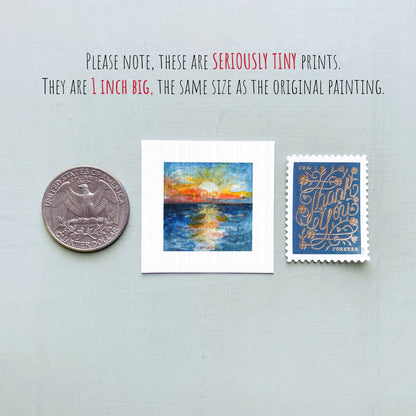 three small artworks: a quarter, a square print of a sunset, and a postage stamp.
