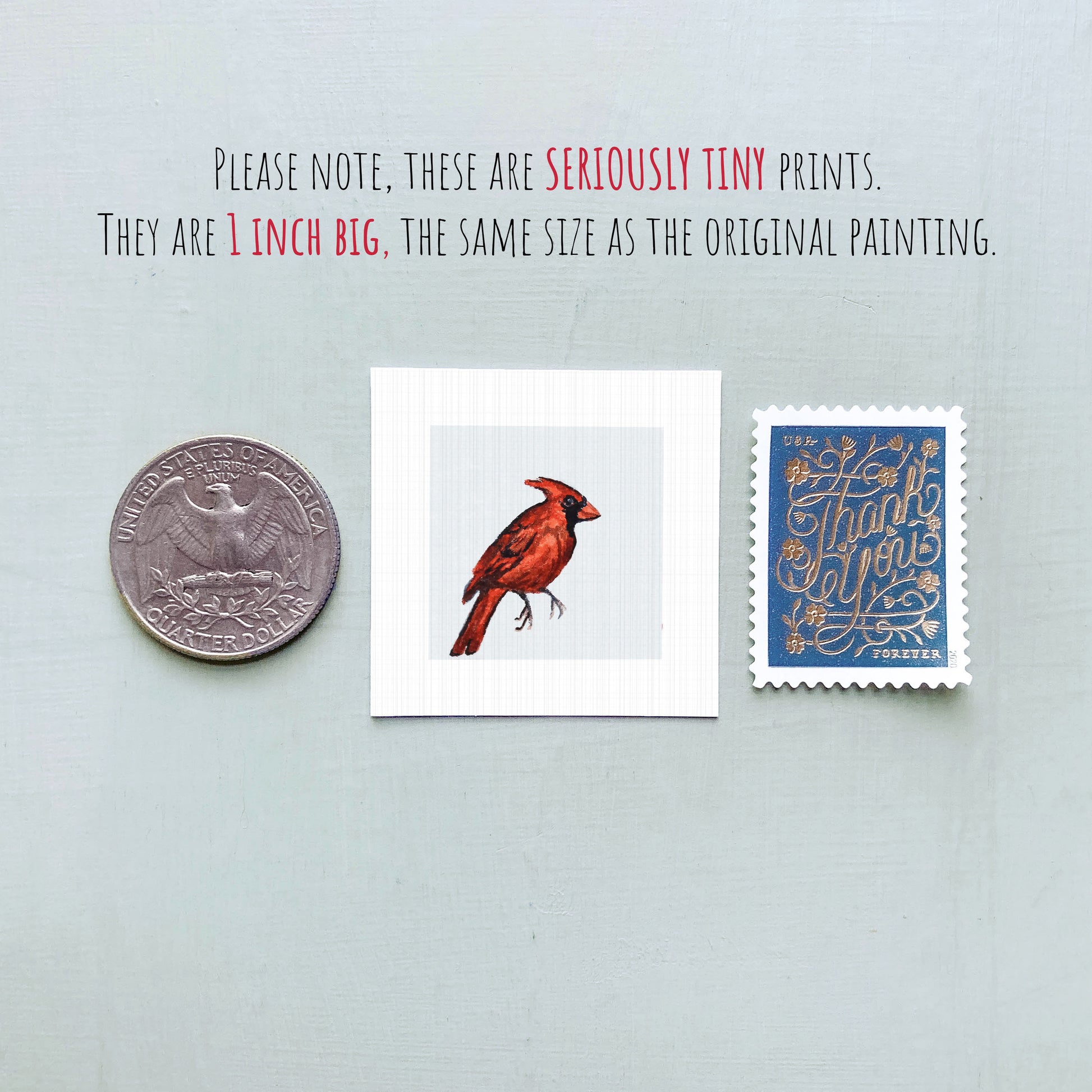 a collection of three small items: a quarter, a piece of paper with a red bird illustration, and a postage stamp.