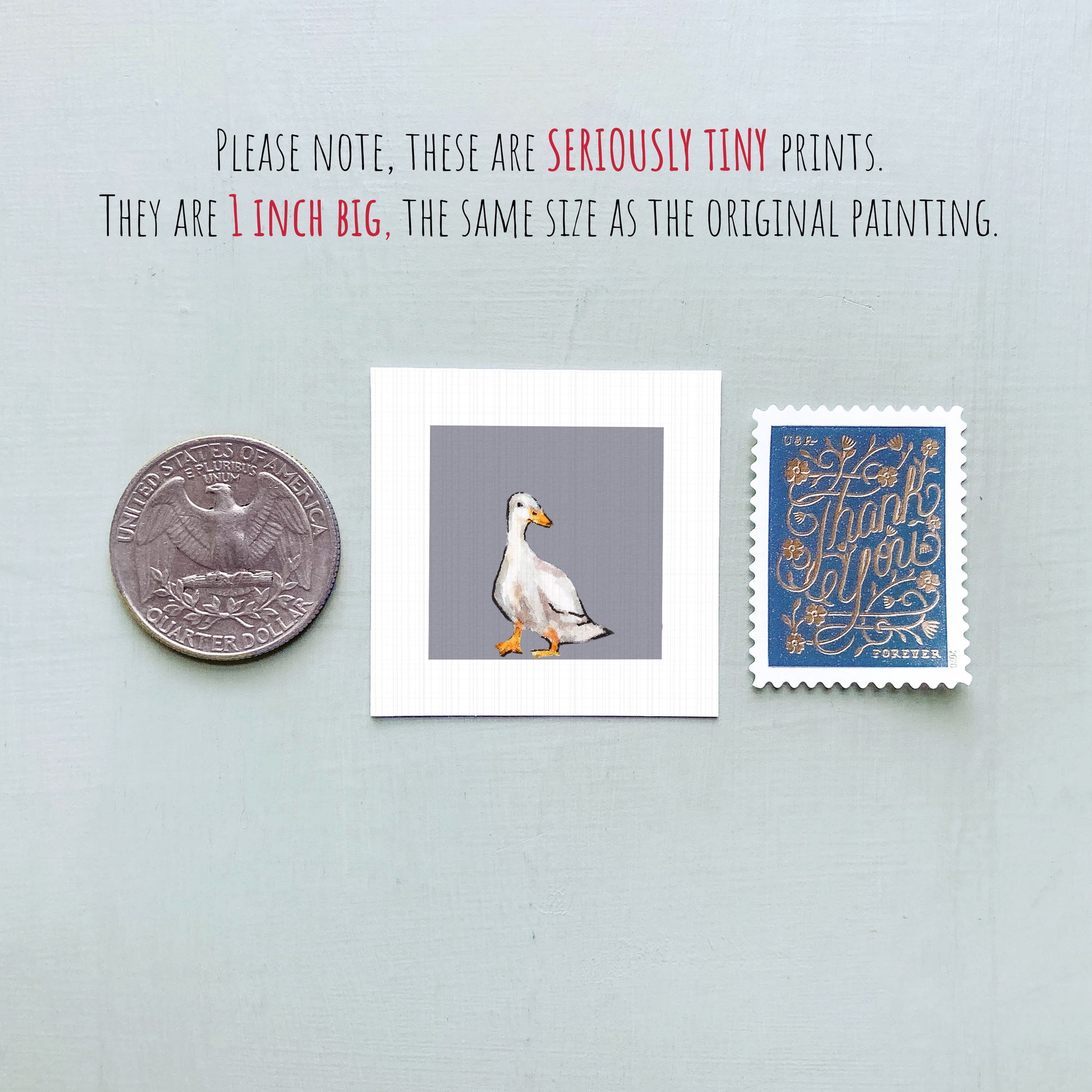 a collection of three small items: a quarter, a square print of a duck, and a postage stamp.