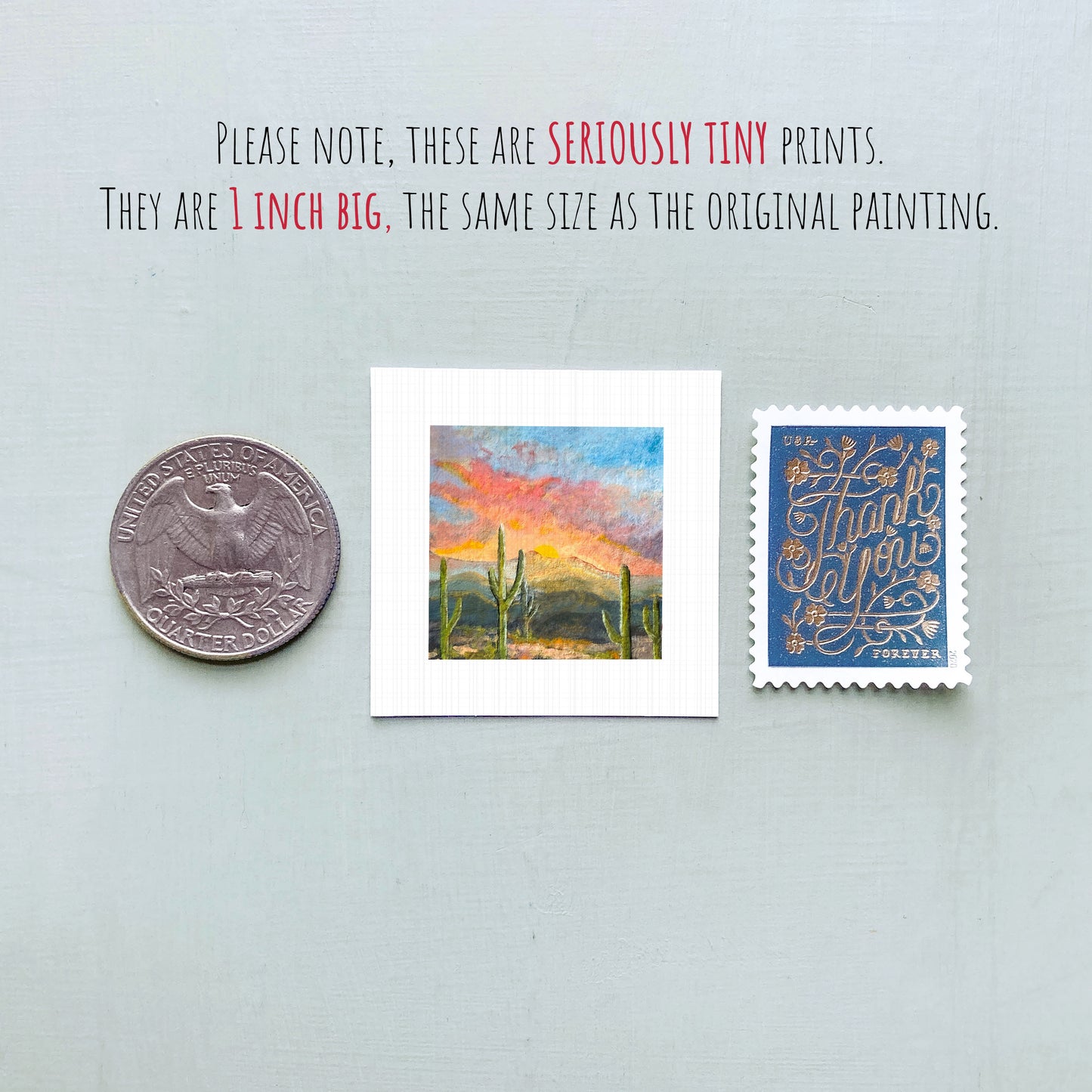 three small prints: a quarter, a painting of a desert landscape, and a postcard with a handwritten message.