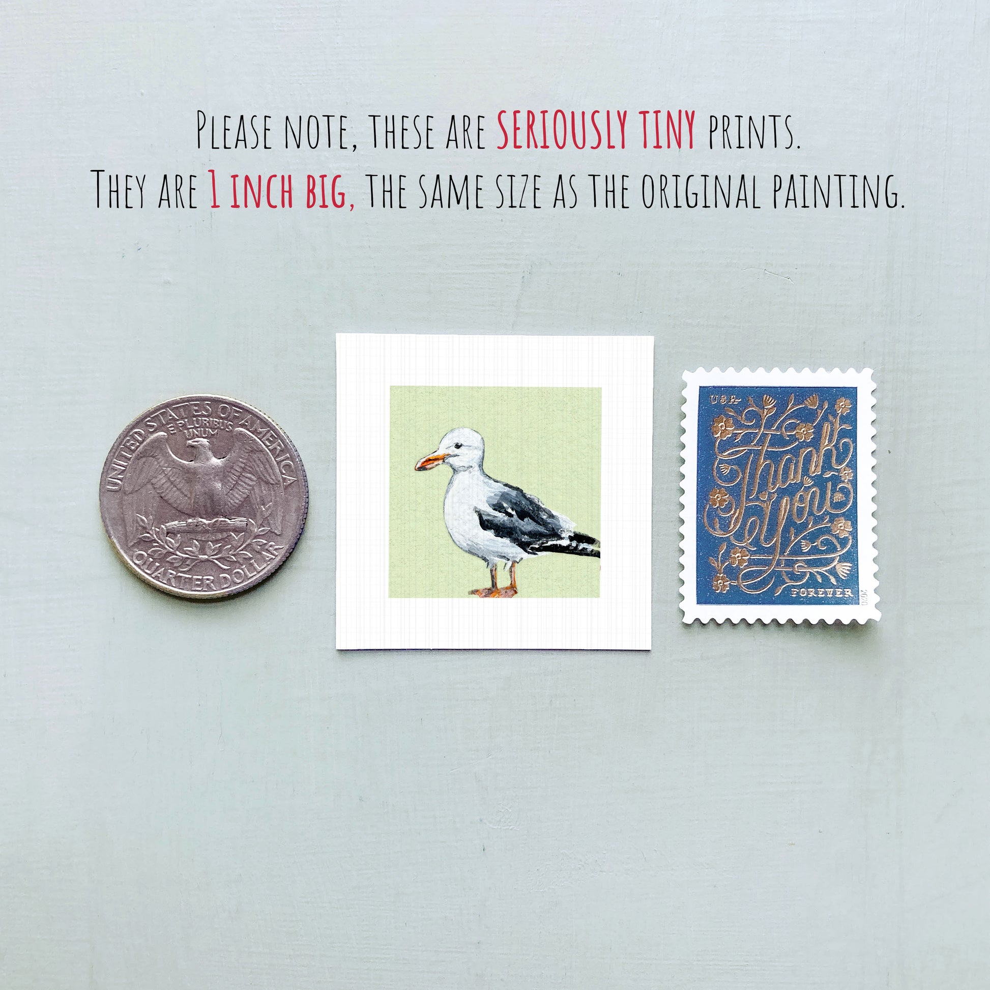a small, 1-inch-big painting of a seagull, a United States quarter, and a blue postage stamp.