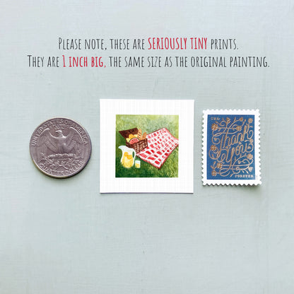 three small prints: a quarter, a square print of a picnic scene, and a postage stamp.