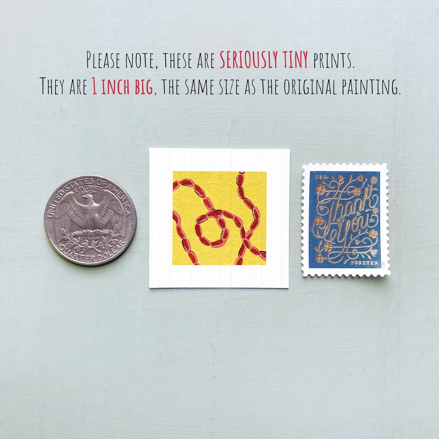 three small artworks, including a quarter, a square with a yellow and red design, and a blue postage stamp, all of which are described as "seriously tiny prints" and "1 inch big" in the provided text.