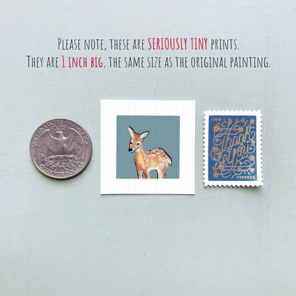 a collection of three small items: a quarter, a square print of a deer, and a postage stamp.