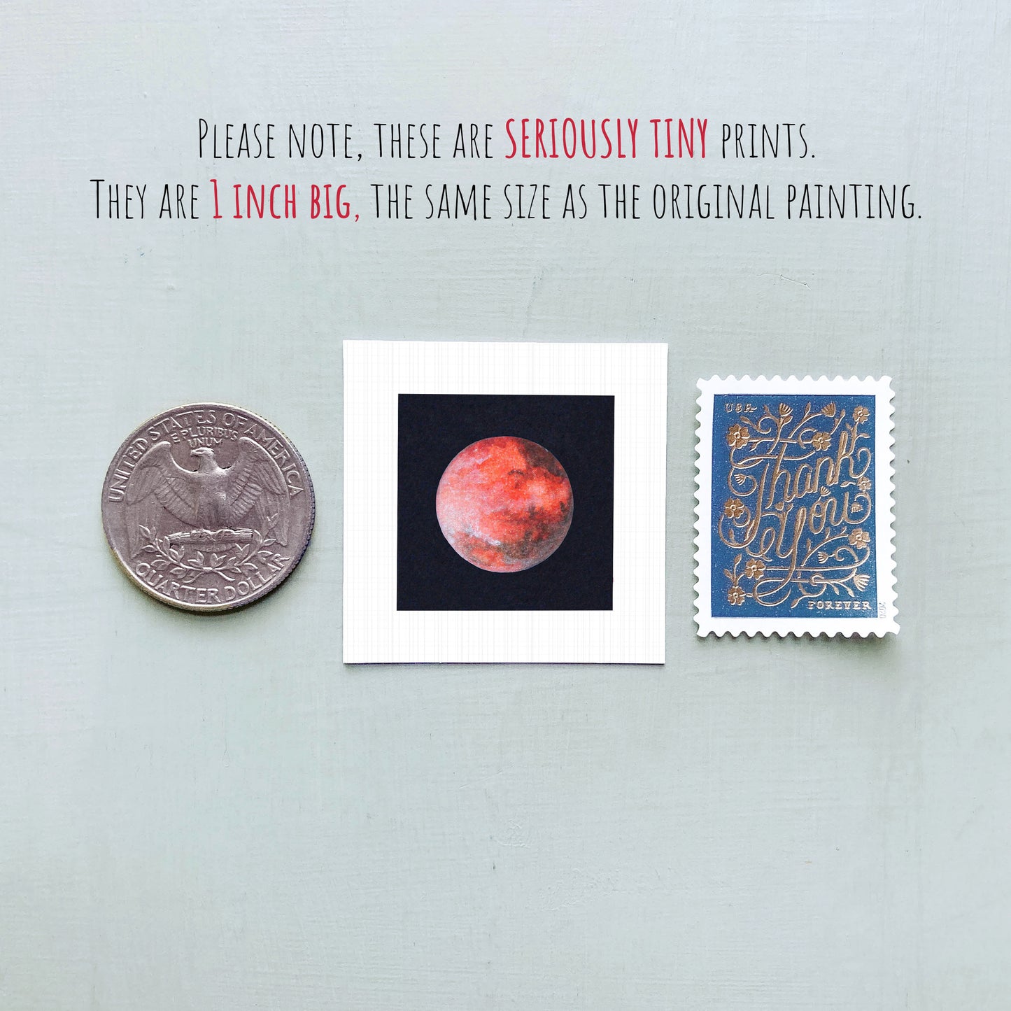 three small prints: a silver coin, a white square print of a red planet, and a blue postage stamp with gold lettering.