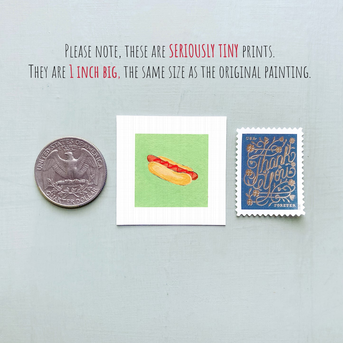 three small items: a quarter, a square print of a hot dog, and a postage stamp.