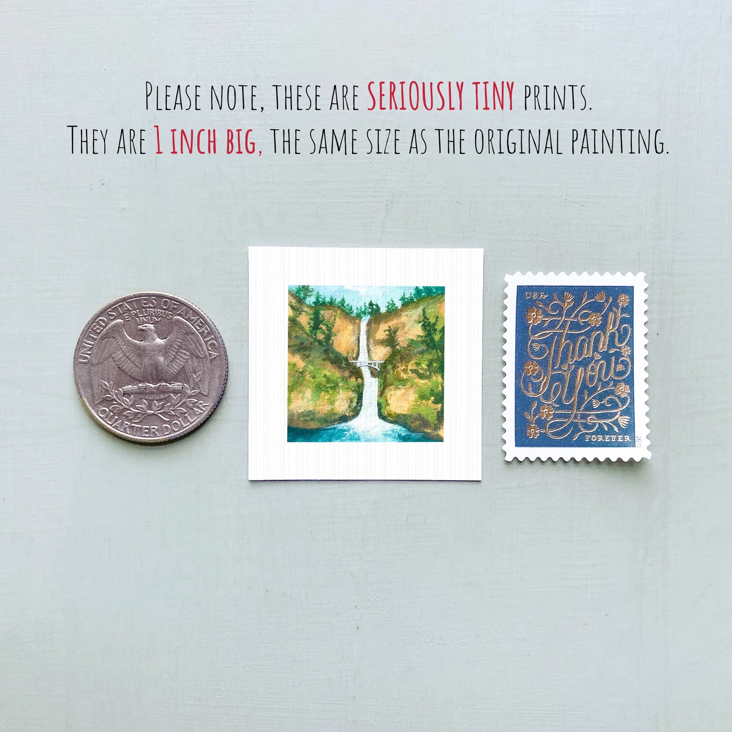 three small prints: a quarter, a postage stamp, and a painting of a waterfall.