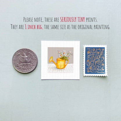 a collection of three small items: a quarter, a square print of a flowery vase, and a blue postage stamp.