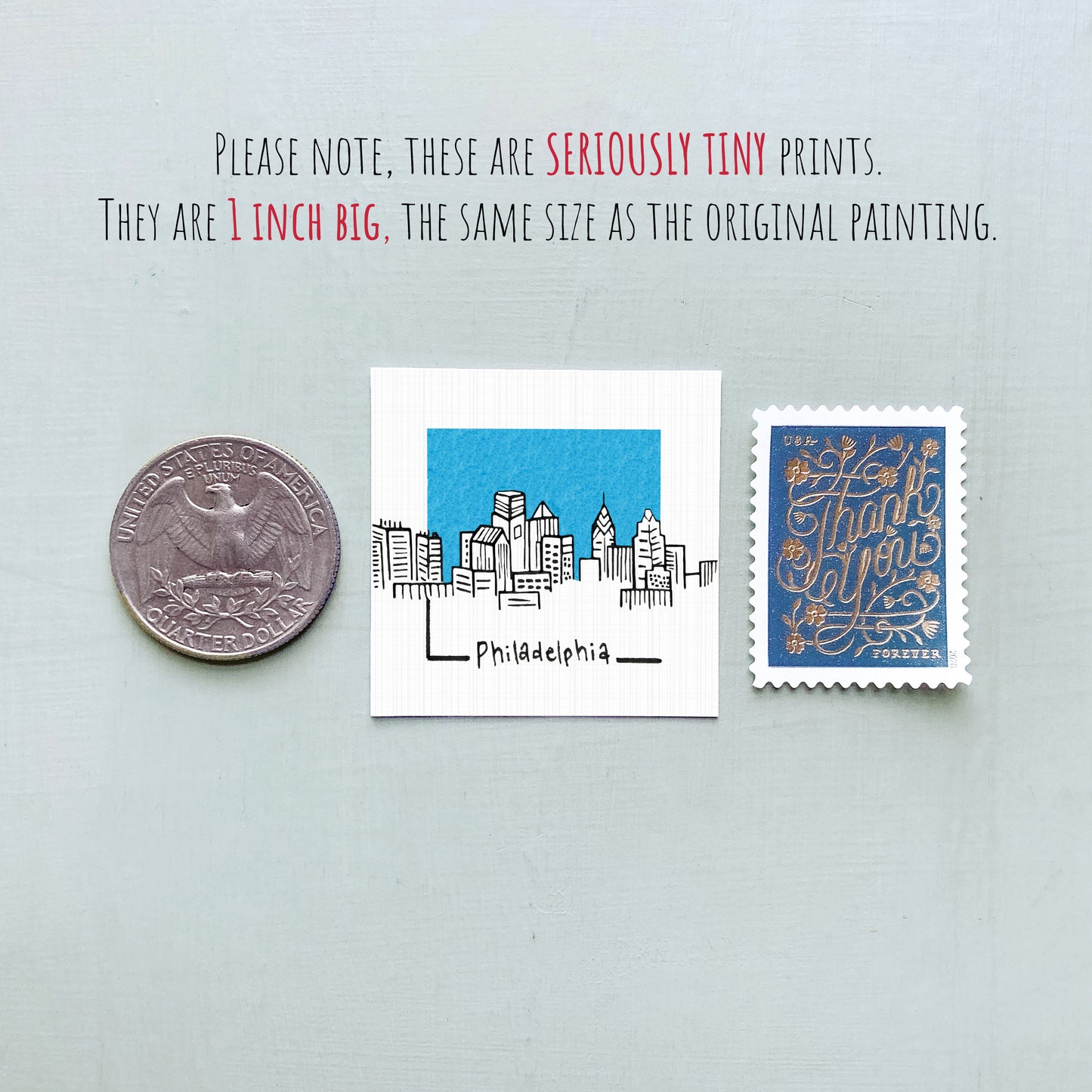 three different objects: a quarter, a small square with a drawing of a city skyline, and a postage stamp.