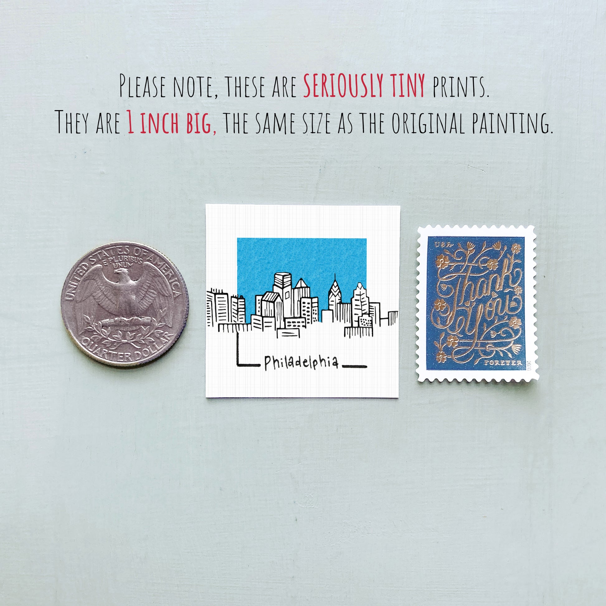 three different objects: a quarter, a small square with a drawing of a city skyline, and a postage stamp.