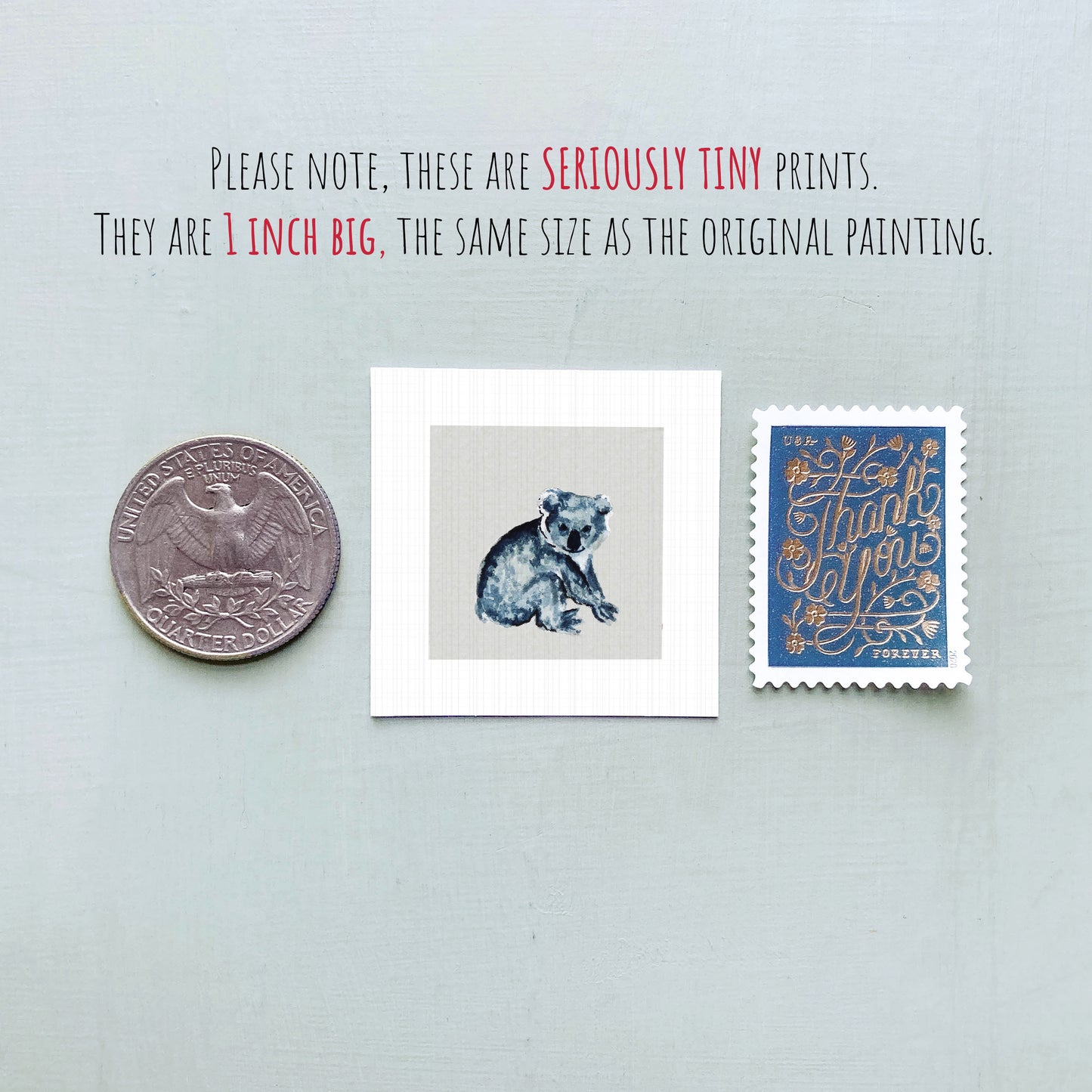 three small artworks: a quarter, a square print of a koala bear, and a postage stamp.