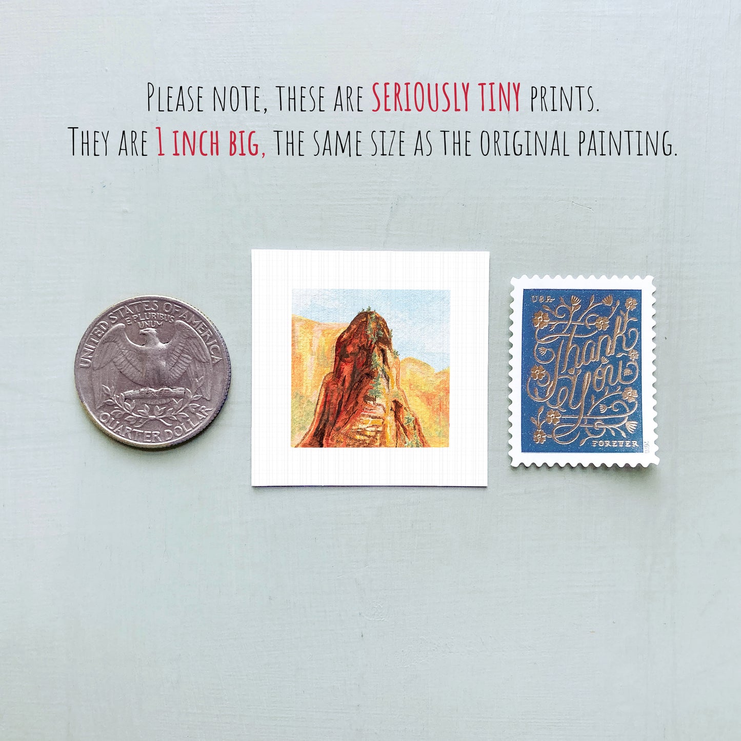 a collection of three small items: a quarter, a postage stamp, and a painting of a mountain.