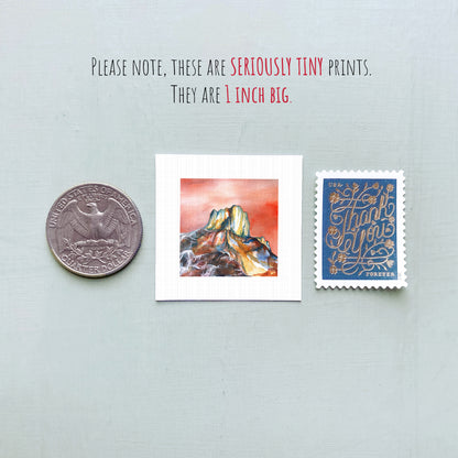 a collection of three small items: a quarter, a square print of a mountain landscape, and a postage stamp.