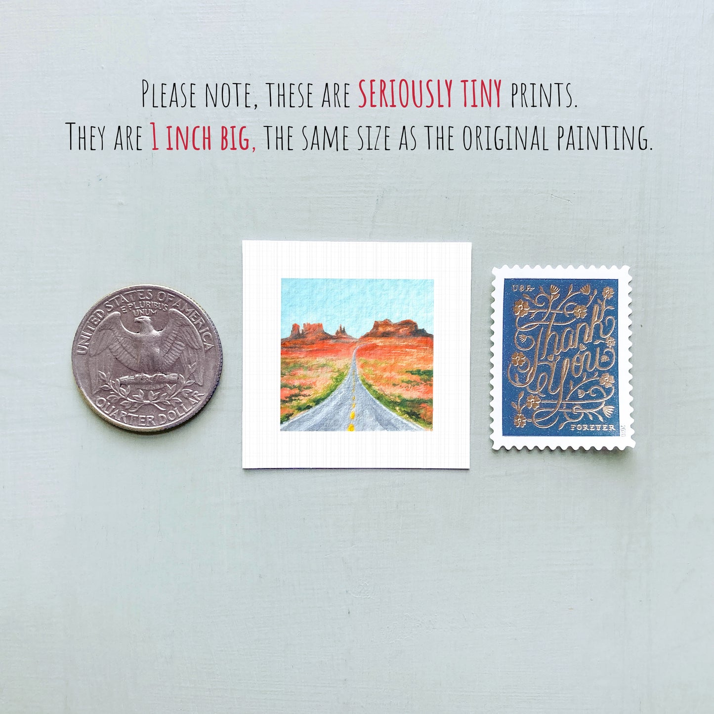 a collection of three small items: a quarter, a miniature painting of a road, and a postage stamp.