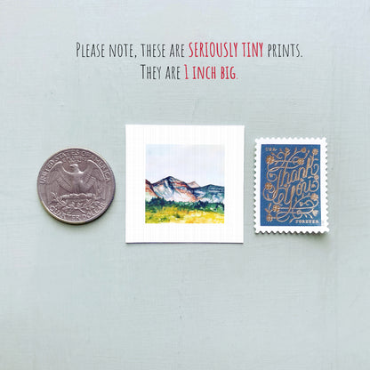 a collection of three small prints, including a coin, a postcard, and a stamp, all of which are described as "seriously tiny prints" and "1 inch big".