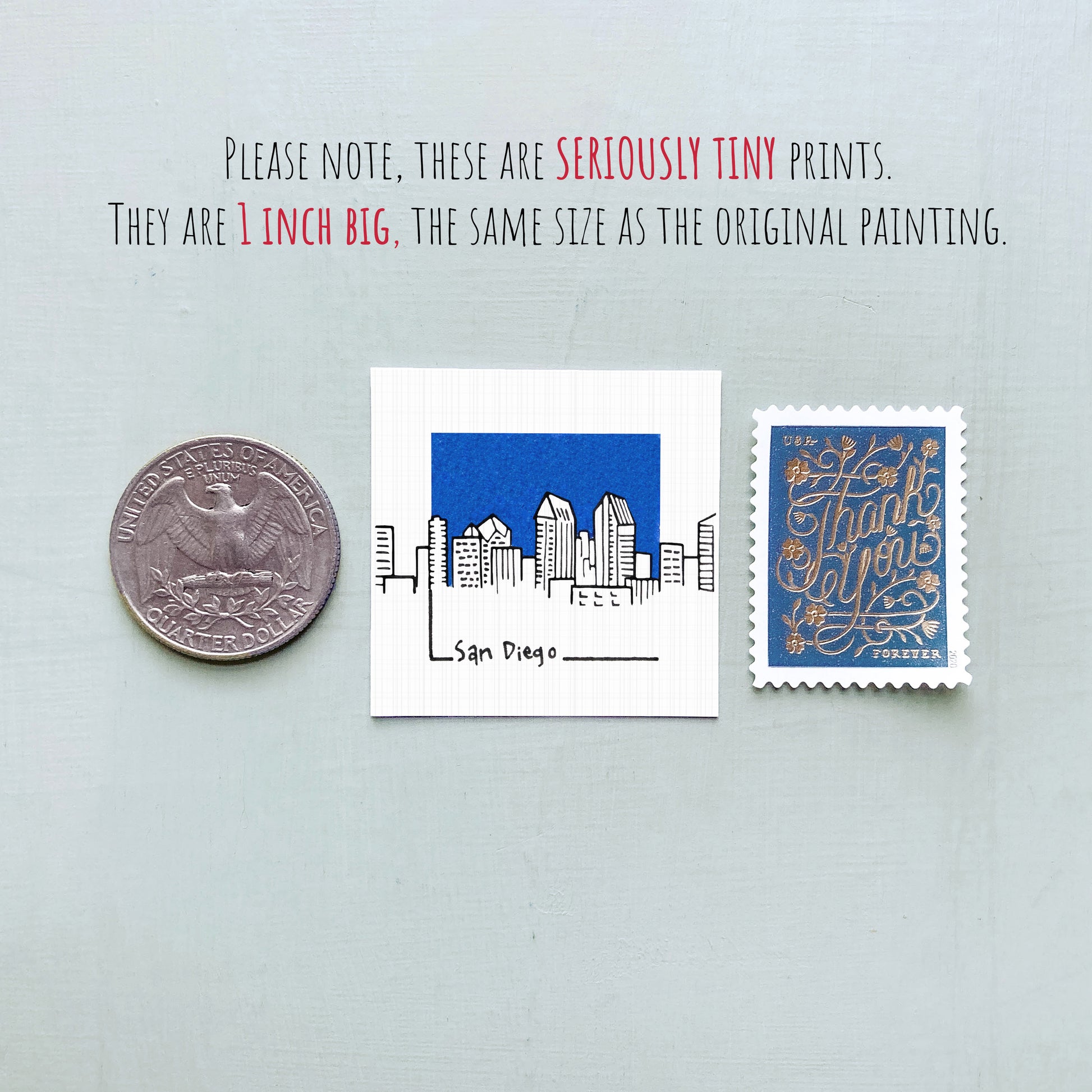 three small prints: a coin, a postage stamp, and a square print depicting a city skyline.