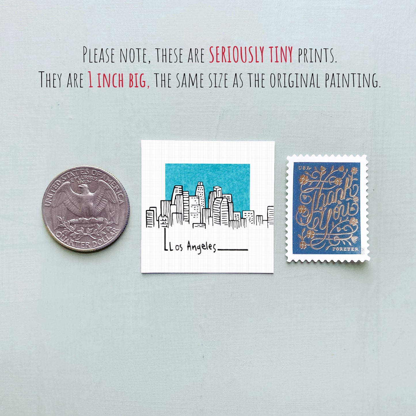 a collection of three small items: a quarter, a postage stamp, and a miniature painting of Los Angeles.