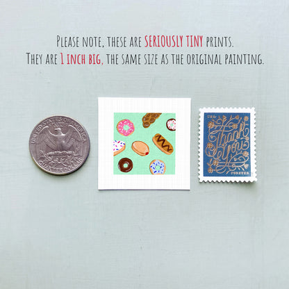 three small prints: a silver coin, a square print with colorful donuts, and a blue postage stamp with gold lettering.