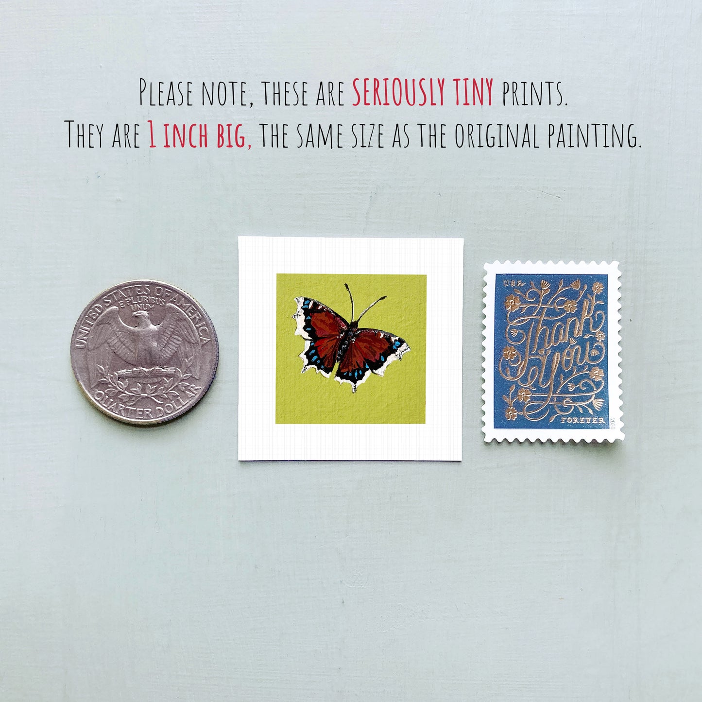 three small prints: a silver coin, a white square print of a butterfly, and a blue postage stamp.
