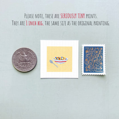 three small items: a quarter, a postage stamp, and a miniature painting of a bowl of cereal.
