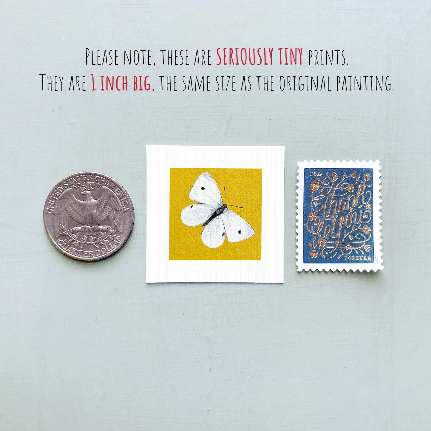 three small prints: a silver coin, a yellow square print of a butterfly, and a blue postage stamp.