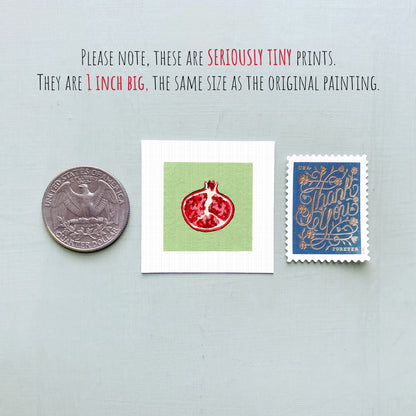 three small, seriously tiny prints: a United States quarter, a square print with a red pomegranate design, and a blue postage stamp with gold lettering.