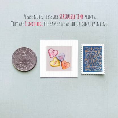 three small items: a United States quarter, a heart-shaped candy with the words "Merry Valentine's Day", and a postage stamp.