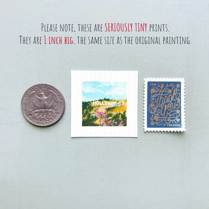 three small prints: a United States quarter, a miniature painting of Hollywood, and a postage stamp.