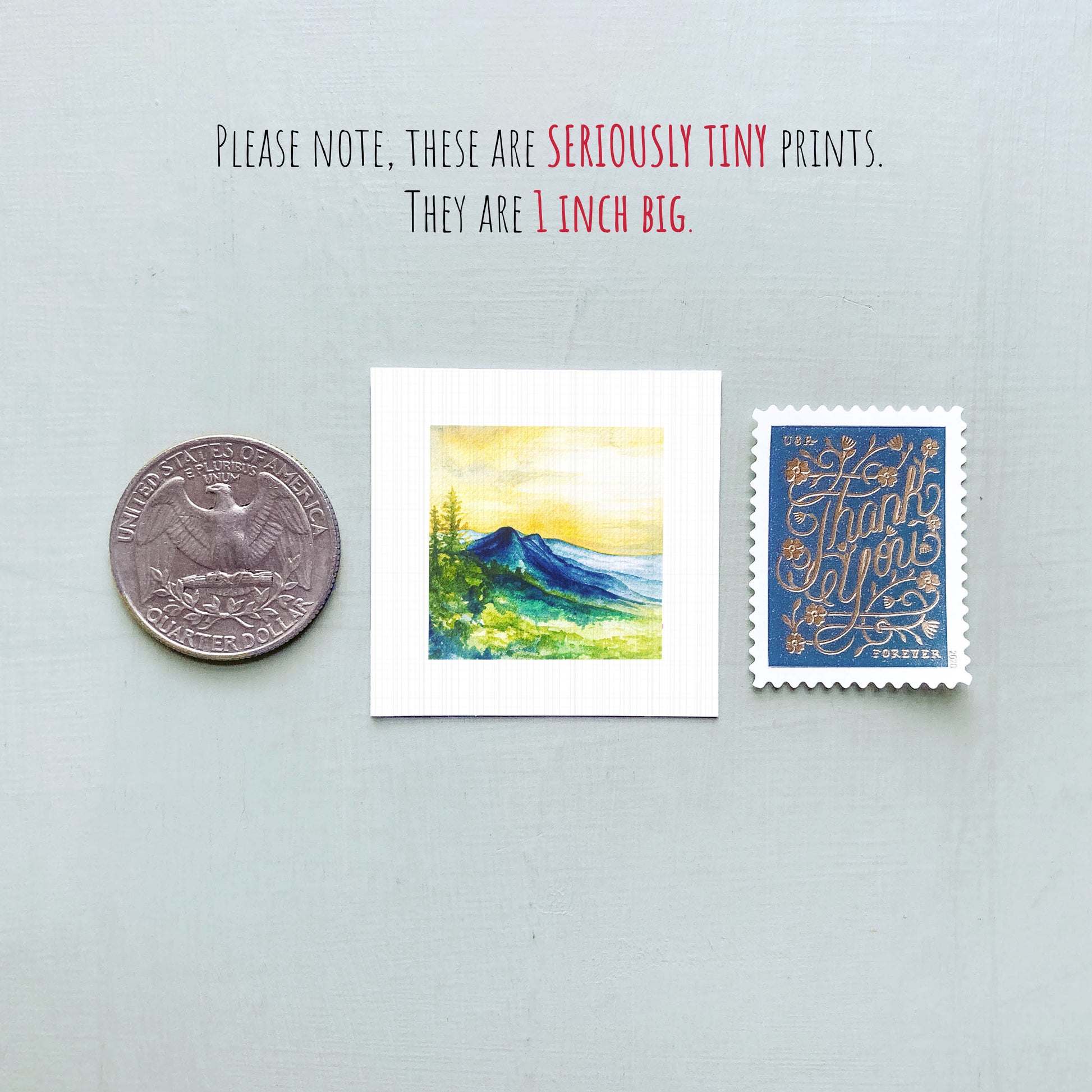 a collection of three small items: a quarter, a watercolor painting of a mountain landscape, and a postage stamp.
